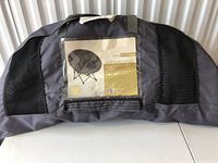 Carrying bag with front label showing Room Essentials black corduroy sphere chair image and text.