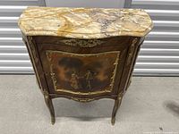 Front view of side table showing marble top and painted front panel