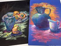 Both pastel paintings side by side, showcasing their colorful still life subjects and textured pastel strokes.