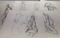 Five figure study drawings on paper, each measuring about 19 x 25 inches, shown overlapping on a surface. Various poses in charcoal or pastel, monochrome sketches.