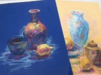 Photo of two pastel paintings side by side on a flat surface showing their sizes and color contrasts