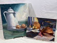 Both paintings shown together on display stands, highlighting size and condition.