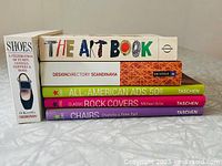 Front stacked view of the six books showing the spines with titles and publishers