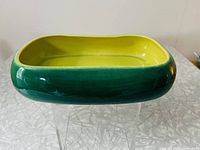 View of the rectangular green pottery planter showing glossy green glaze exterior and yellow-green interior.