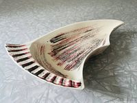 Angle view of the vintage mid-century ceramic dish showing its shape and brushstroke pattern.