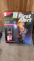 Front of the First Alert fire escape ladder box showing image of product and usage.