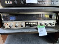 Front view of a Kenwood KR-4140 stereo receiver showing control knobs and display window.