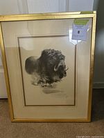 Full view of framed print showing musk ox and gold frame