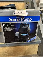 Box of Mastercraft submersible sump pump with detailed product specs and branding visible.
