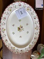 Full view of the oval serving platter showing the floral pattern and scalloped edges.