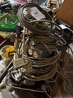 Photo showing a large coiled bundle of various types of cables including coaxial and power plugs.