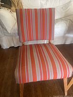Pair of antique accent chairs from the 1950s, showing striped upholstery and wood legs