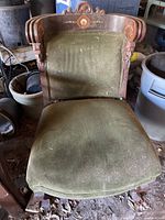 Full view of antique parlour chair showing green upholstered seat and backrest with carved wooden frame