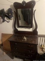 Full view of the antique oak dresser with mirror showing the front drawers and mirror frame with carvings
