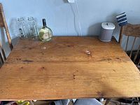 Top view of antique pine table showing natural wood surface with wear marks.