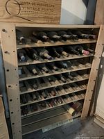 Front view of wooden wine rack filled with wine bottles showing overall design and size