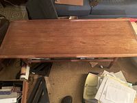 Top view of solid teak rectangular coffee table showing wood grain and condition.