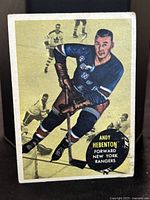 Front of 1961-62 Andy Hebenton #55 Topps hockey card showing player in Rangers uniform skating with hockey stick.