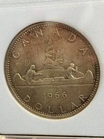 Front side (reverse) of 1966 Canadian $1 coin showing canoe and date.