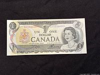 Front image of the 1973 Bank of Canada one dollar bill showing Queen Elizabeth II and the denomination.