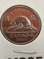 Reverse side of the 1964 Canadian 5 cent coin showing a beaver on a log, the year 1964, and maple leaves.