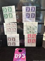 Six different blocks of four Canadian early Queen Elizabeth II stamps in various colors, showing mint condition and printed plate numbers on the margins.