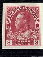 Close-up front view of the mint condition Canadian 3 cent Admiral stamp showing King George V portrait in detailed red printing with no perforations.