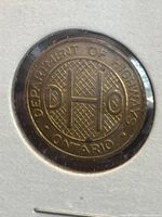 Photo of the obverse side of the Ontario Department of Highways toll token with 'H' symbol and text 'DEPARTMENT OF HIGHWAYS ONTARIO'.