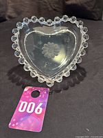 Heart shaped glass dish with distinctive Candlewick pattern beaded rim and cornflower etched floral design at center.