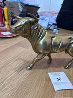 Side view of the brass bull statue showing detailed face and horns.