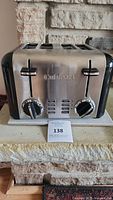Front side view of stainless steel Cuisinart toaster showing brand name and control knobs.