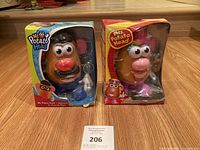 Mr. and Mrs. Potato Head toys packaged in original boxes with visible wear and tear on the boxes.