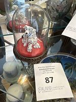 Porcelain Disney 101 Dalmatians glass dome figurine showing Perdita and puppies on red base with ornate decorative gold and black base ring.