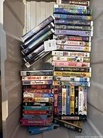 Photo showing the full lot of VHS tapes stacked neatly in a storage bin.