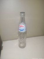 Front view of the vintage Pepsi-Cola glass bottle showing the label and bottle design
