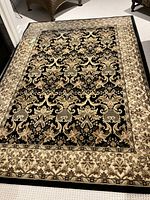 Full view of the area rug laid flat showing the overall pattern and colors.