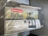 Packaging showing the Rubbermaid Tool Tower with branding and capacity details under plastic wrap.
