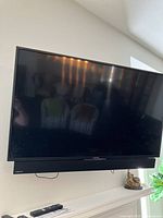 Front view of the Sony flat screen TV showing the Samsung sound bar mounted underneath the screen.
