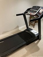 Full view of Frequency Fitness treadmill showing deck, handrails and console.