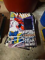 Stack of Marvel X-Men comic books featuring a hologram cover with Magneto and Wolverine on the front. Covers show some dirt and wear.