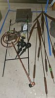 Lot showing copper sprinkler, metal garden hose guides, metal pond reeds, and slate pavers.
