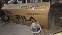 Full view of sealed original cardboard box labeled FILA CYCLES, promotional bike box text visible.