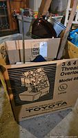 Original cardboard box for Toyota Model 6600 3 & 4 Thread Overlock sewing machine showing model and graphic