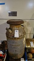 Full view of large vintage Foodcraft milk can showing body and lid with rust and brand name