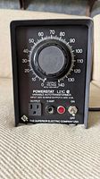 Front view of Superior Electric Powerstat L21C variable autotransformer showing rotary dial, voltage scale, power switch, fuse, and input/output terminals.