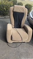 View of beige and black fabric electric chair with wired control on seat