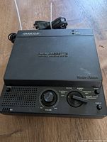 Closed view of the Radio Shack Duofone TAD-212 answering machine showing the volume knob, playback and recording switch with power and microphone indicators.