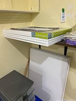 Stack of 24x36 inch canvases with one white canvas below