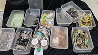 Overview of various beads and jewellery wire rolls stored in plastic containers