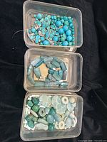 Overview of three containers with mixed beads in blue/green tones including turquoise, agate and larimar beads